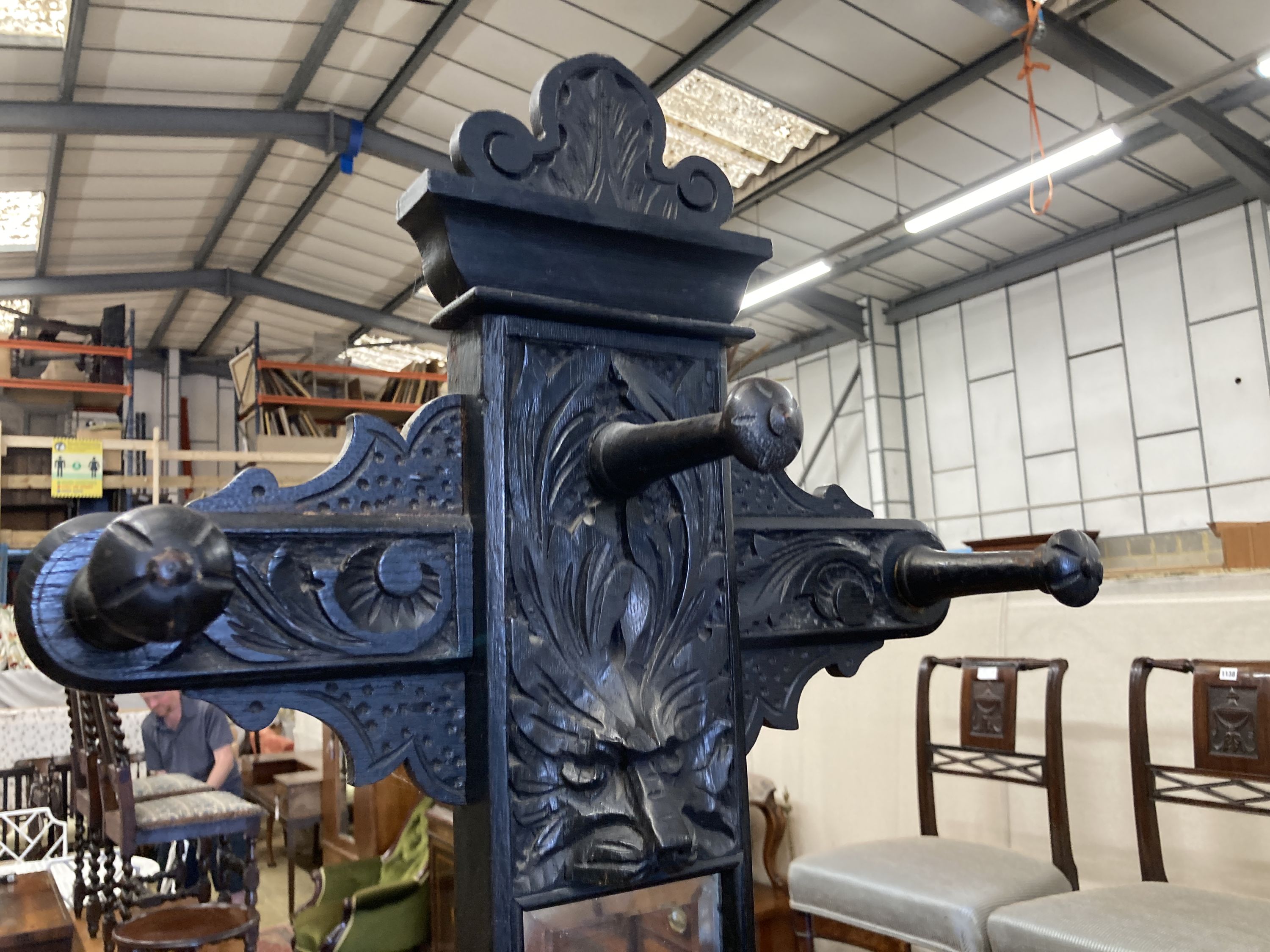 An early 20th century Flemish carved oak hall stand, width 60cm, depth 25cm, height 208cm